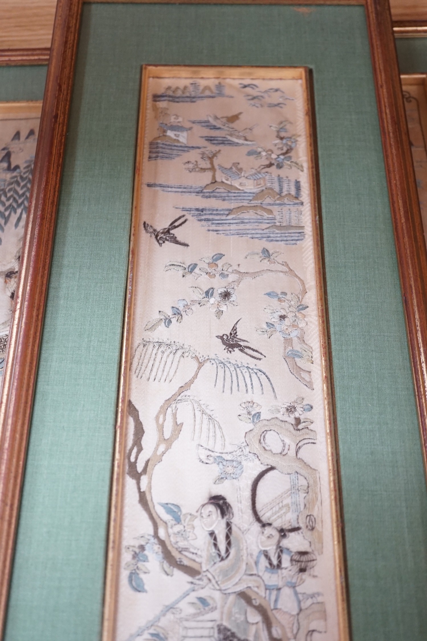 Three pairs of gilt framed, 19th century, silk embroidered, sleeve bands (for Chinese robes), 49cms long x 9cms wide (not including mount or frame)